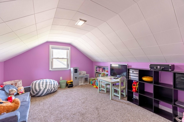 recreation room featuring vaulted ceiling and carpet