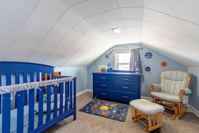 bedroom featuring carpet floors, a nursery area, and lofted ceiling