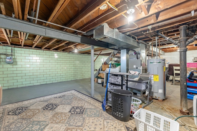 unfinished below grade area with concrete block wall and electric water heater