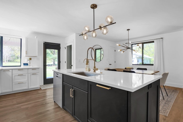 5300 Clark State Rd, Columbus, OH 43230 - kitchen with light countertops, white cabinetry, a notable chandelier, and wood finished floors