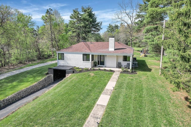 5300 Clark State Rd, Columbus, OH 43230 - view of front of home with brick siding, a front lawn, covered porch, and a chimney
