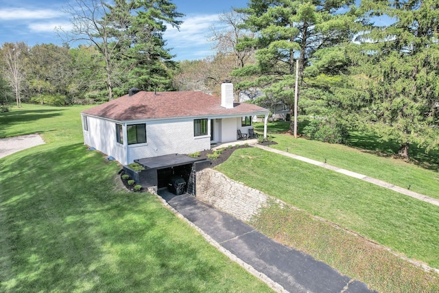 5300 Clark State Rd, Columbus, OH 43230 - view of front of house with brick siding, a front lawn, driveway, and a chimney