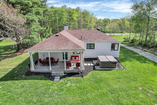 5300 Clark State Rd, Columbus, OH 43230 - rear view of house with a hot tub, a lawn, a chimney, and roof with shingles