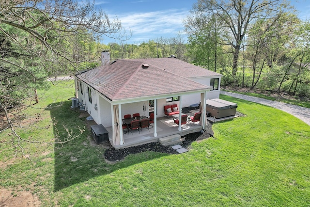 5300 Clark State Rd, Columbus, OH 43230 - exterior space featuring a shingled roof, a hot tub, a wooden deck, and a yard
