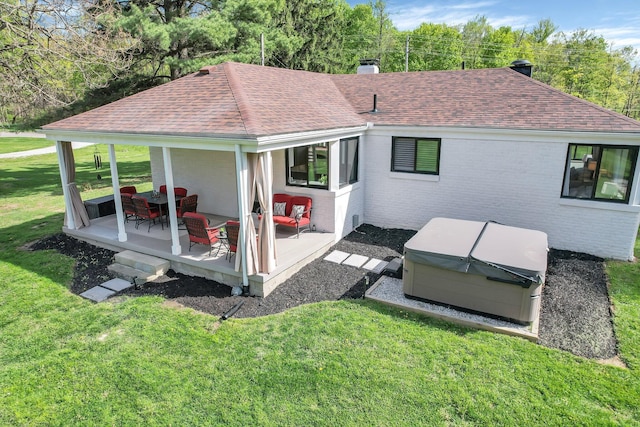 5300 Clark State Rd, Columbus, OH 43230 - rear view of house with a shingled roof, a hot tub, a yard, and a chimney