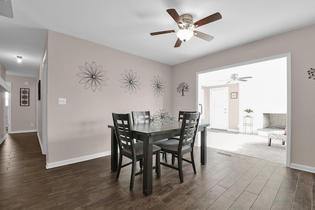 895 Janet Dr, Columbus, OH 43224 - dining area featuring a ceiling fan, baseboards, and dark wood-style floors