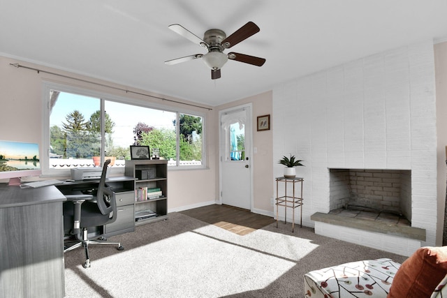 895 Janet Dr, Columbus, OH 43224 - home office featuring baseboards, a ceiling fan, carpet, and a fireplace