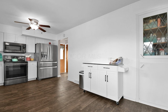 895 Janet Dr, Columbus, OH 43224 - kitchen with a ceiling fan, dark wood-style flooring, light countertops, white cabinets, and stainless steel appliances