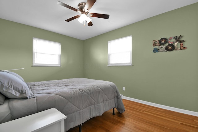 895 Janet Dr, Columbus, OH 43224 - bedroom with baseboards, ceiling fan, multiple windows, and wood finished floors