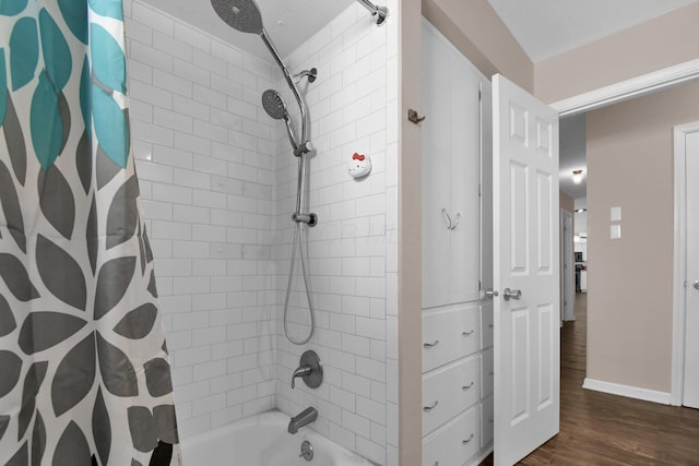 895 Janet Dr, Columbus, OH 43224 - full bath with baseboards, shower / bath combo, and wood finished floors
