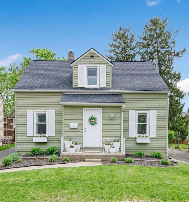 233 Girard Rd, Columbus, OH 43214 - cape cod home with a shingled roof, a chimney, and a front yard