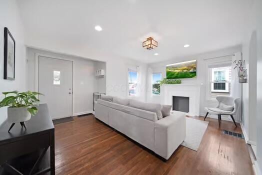 233 Girard Rd, Columbus, OH 43214 - living room with recessed lighting, a fireplace, dark wood finished floors, and a wealth of natural light