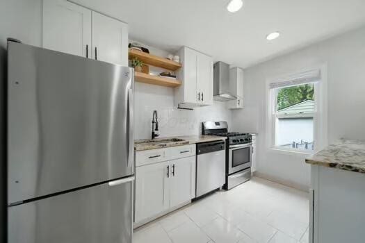 233 Girard Rd, Columbus, OH 43214 - kitchen featuring open shelves, appliances with stainless steel finishes, a sink, wall chimney exhaust hood, and white cabinetry