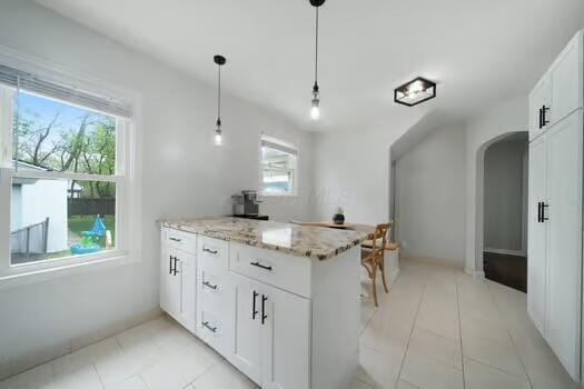 233 Girard Rd, Columbus, OH 43214 - kitchen featuring light tile patterned floors, arched walkways, and a wealth of natural light