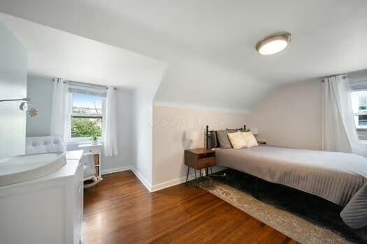 233 Girard Rd, Columbus, OH 43214 - bedroom featuring multiple windows, vaulted ceiling, and wood finished floors
