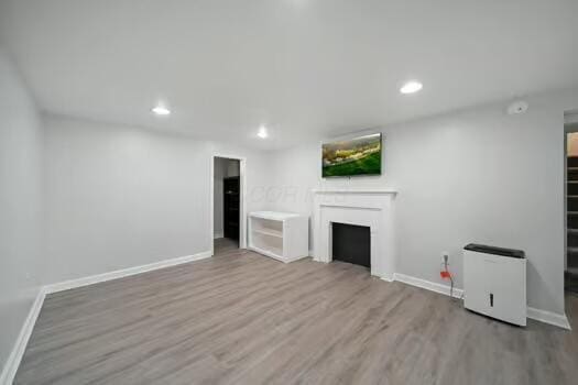 233 Girard Rd, Columbus, OH 43214 - unfurnished living room with baseboards, recessed lighting, wood finished floors, and a fireplace