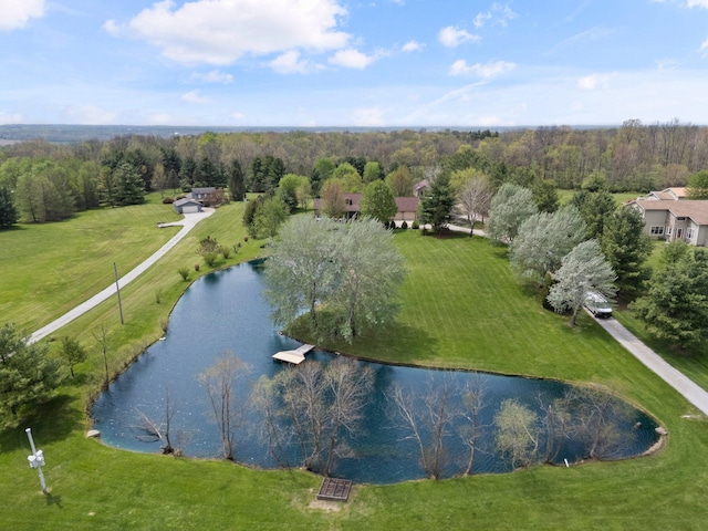 aerial view with a water view and a forest view