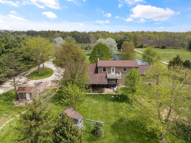 drone / aerial view featuring a wooded view