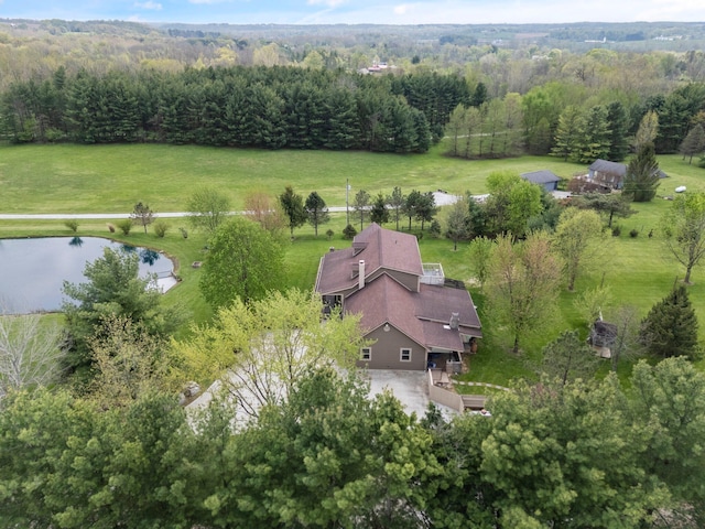 aerial view with a water view and a wooded view