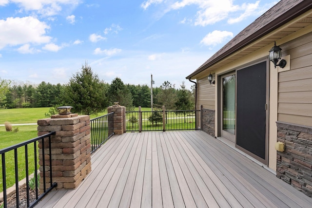 wooden terrace featuring a yard