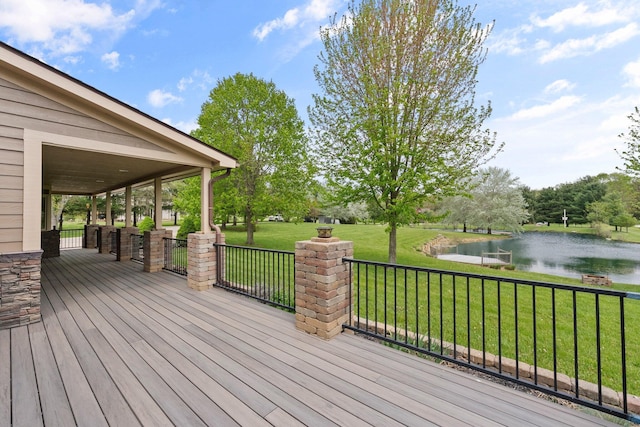 wooden terrace with a lawn and a water view