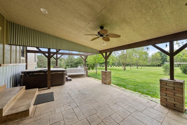view of patio / terrace featuring a hot tub and a ceiling fan