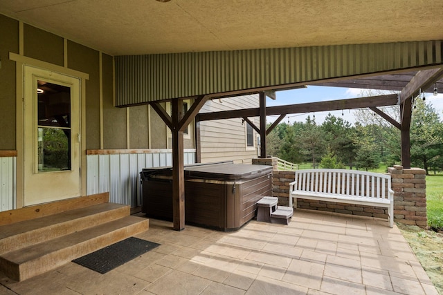 view of patio / terrace with a hot tub