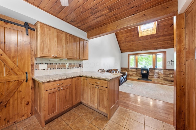 kitchen with wood ceiling, light stone countertops, vaulted ceiling, a peninsula, and open floor plan