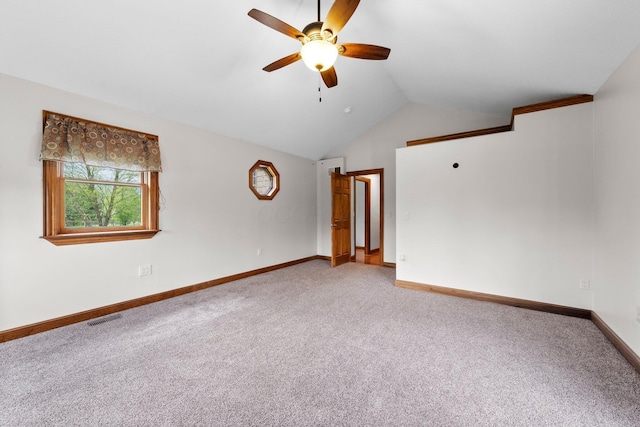 unfurnished room with visible vents, a ceiling fan, lofted ceiling, and light carpet