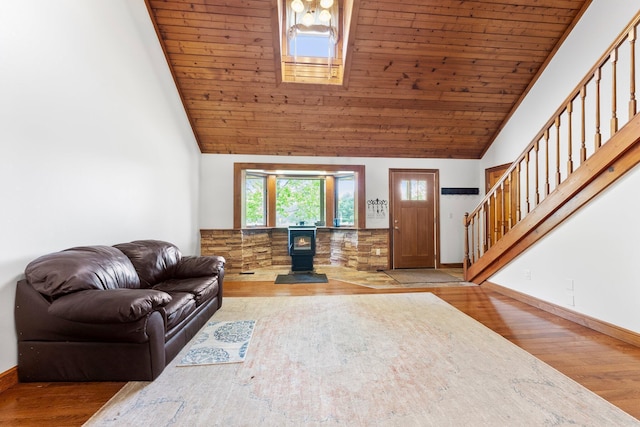 living area with wooden ceiling, a wood stove, stairs, and wood finished floors