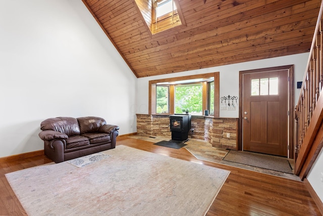 living room with a healthy amount of sunlight, high vaulted ceiling, baseboards, and stairs