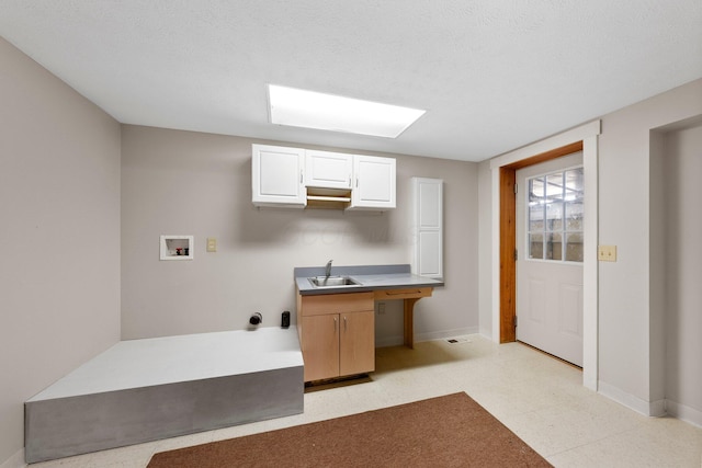 laundry room with laundry area, a sink, baseboards, and washer hookup