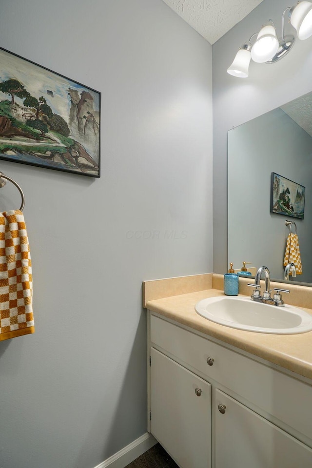 bathroom featuring vanity and a textured ceiling