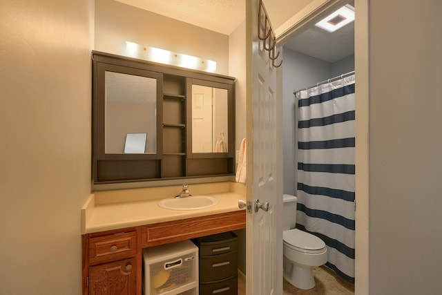 bathroom with vanity, visible vents, toilet, a shower with shower curtain, and a textured ceiling