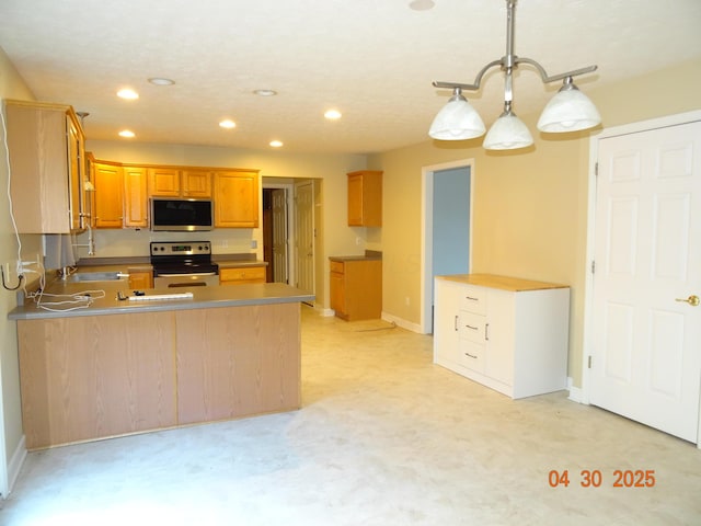 kitchen featuring brown cabinetry, a peninsula, baseboards, recessed lighting, and stainless steel appliances