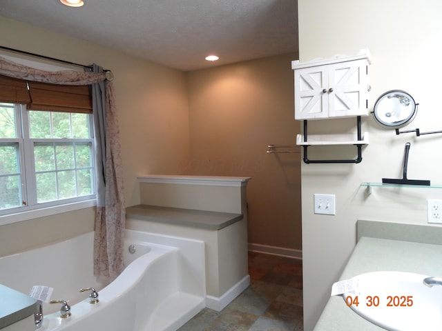 bathroom featuring baseboards, a bathtub, recessed lighting, a shower with curtain, and a sink