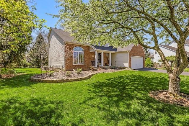 single story home with a front lawn, brick siding, a garage, central AC unit, and driveway