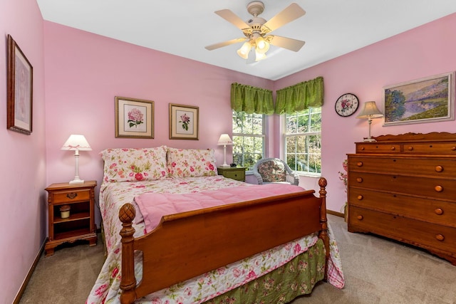 carpeted bedroom with a ceiling fan and baseboards