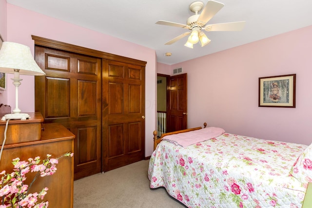 bedroom featuring ceiling fan, light colored carpet, and visible vents