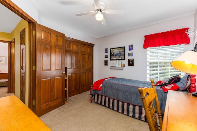 bedroom with a ceiling fan and light colored carpet