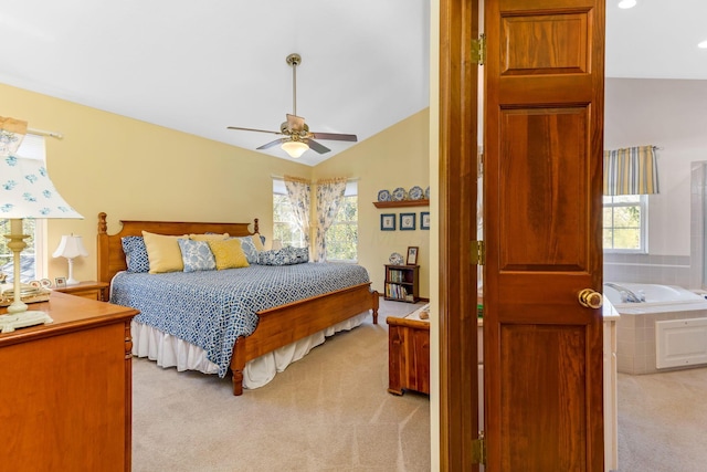 bedroom featuring a ceiling fan, light carpet, and lofted ceiling