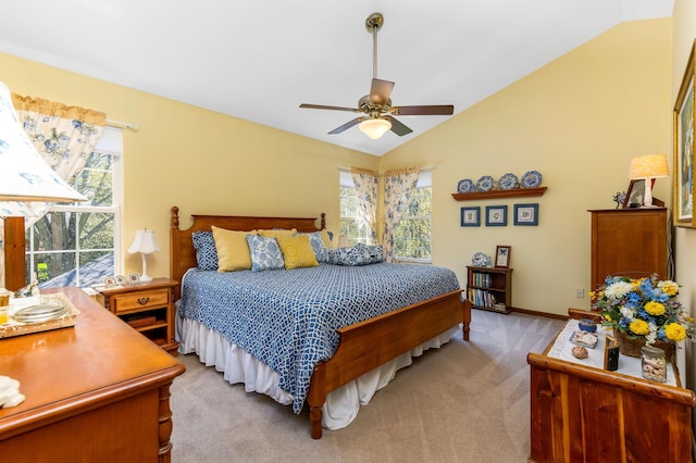 bedroom featuring ceiling fan, lofted ceiling, and light carpet