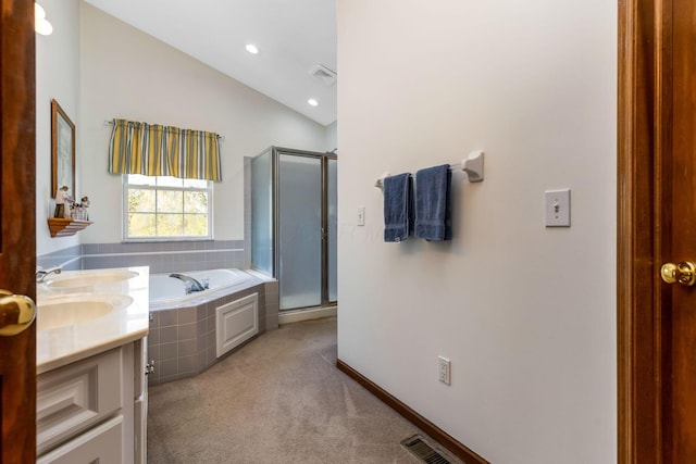 bathroom with a garden tub, a stall shower, lofted ceiling, and visible vents