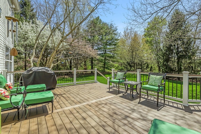 wooden deck featuring a grill