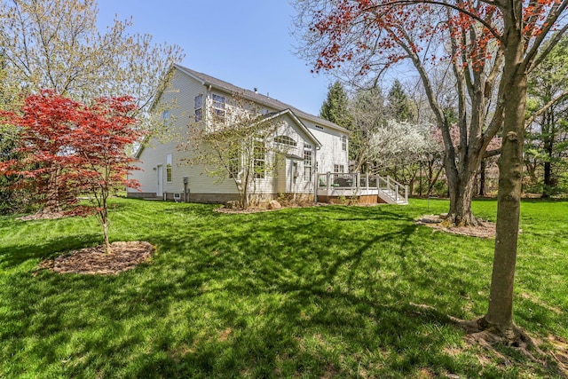 view of side of property featuring a yard and a deck