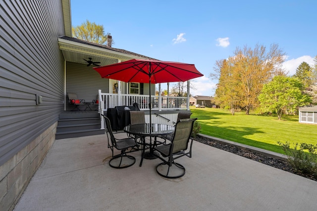 view of patio / terrace featuring a wooden deck, outdoor dining space, and ceiling fan