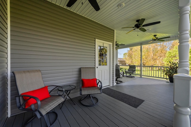 wooden deck featuring covered porch and ceiling fan