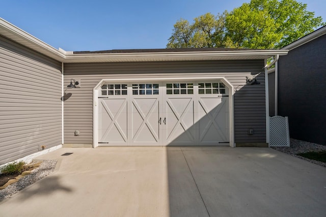 garage featuring concrete driveway