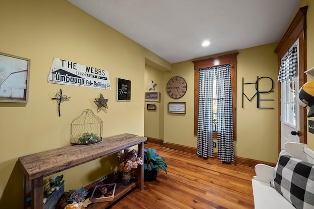 interior space with recessed lighting, baseboards, and wood finished floors