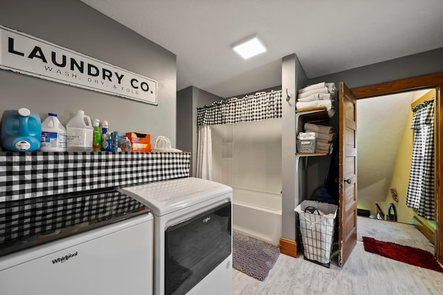 laundry area featuring separate washer and dryer, laundry area, and wood finished floors